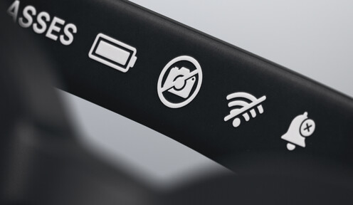 Close-up of the sunglasses arm showing no-camera and no-microphone icons